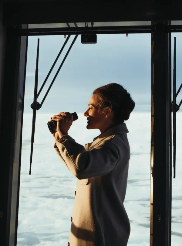 PONANT Shore Excursions Guide-lady using binoculars